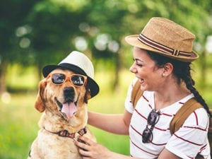 dog wearing hat and sunglasses with owner: Pet Helpful Links in Miami